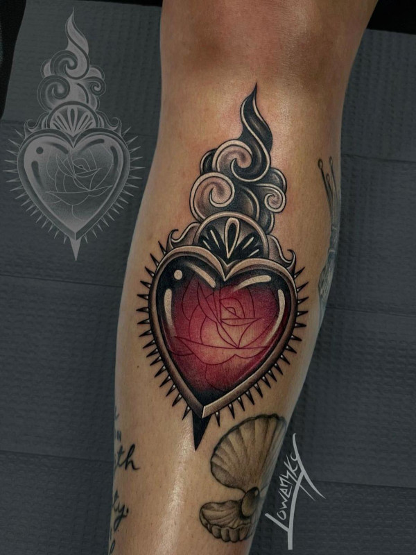 Black and grey with red center calf tattoo of a red jewel heart with a rose etching by Lowensky Santiago of Sacred Mandala Studio in Durham, NC.